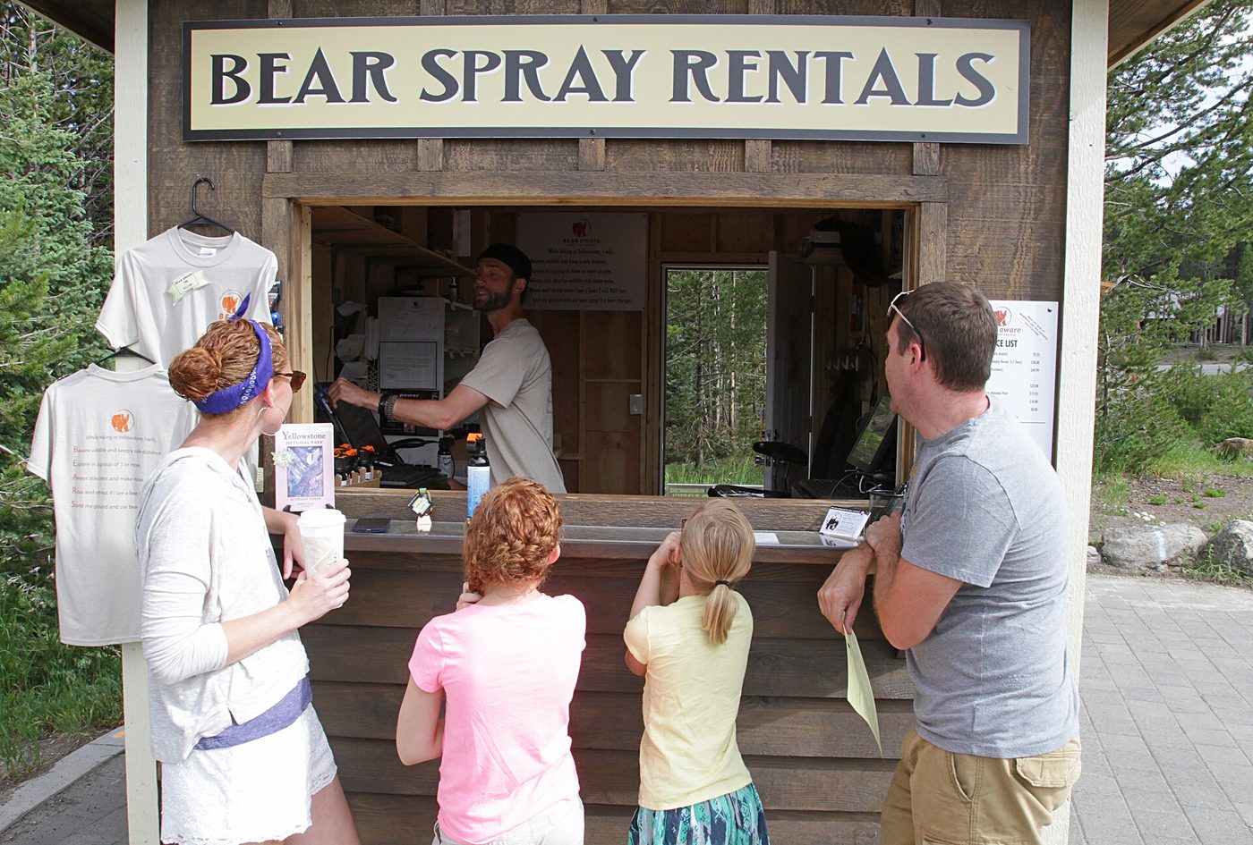 A family at a bear spray rental kiosk at Canyon Village