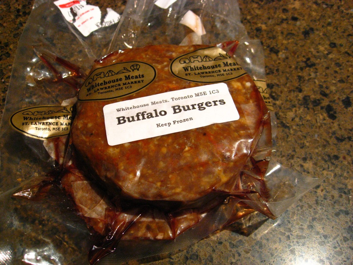 Frozen buffalo burger patties in a labelled vacuum pack