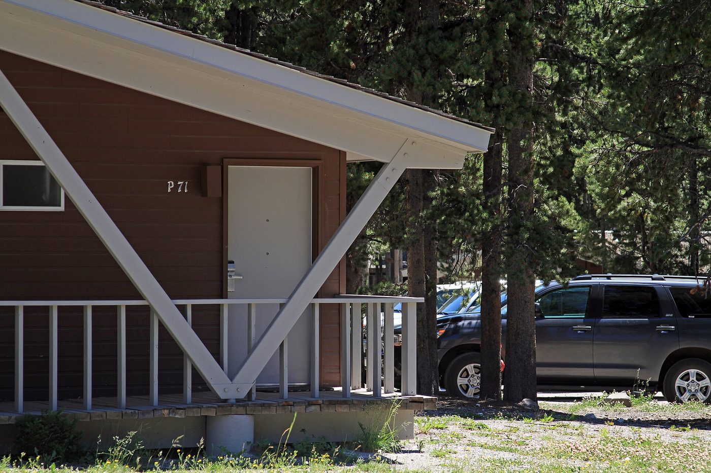 The front of a brown Western cabin with a small porch at Canyon Lodge