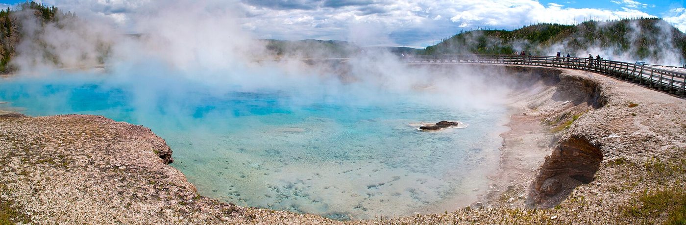 Panorama of the steaming blue Excelsior Geyser Crater beside the boardwalk