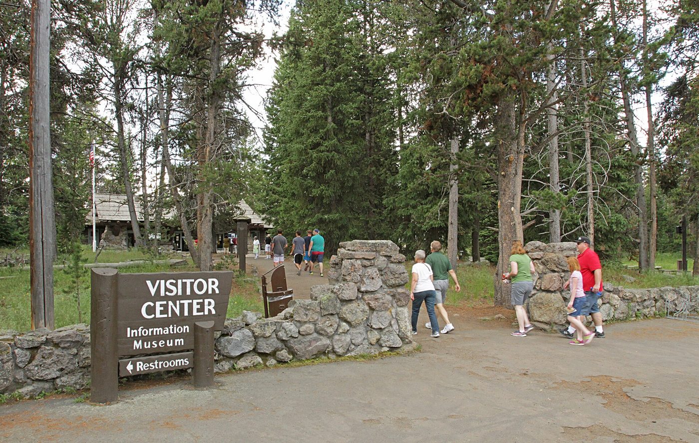 The stone and log Fishing Bridge Visitor Center among lodgepole pines