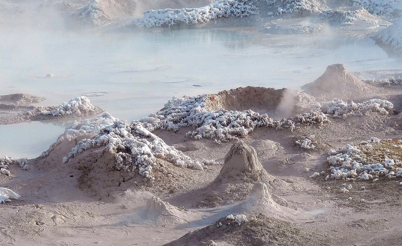 Small cones and craters of gray bubbling mud at Fountain Paint Pot