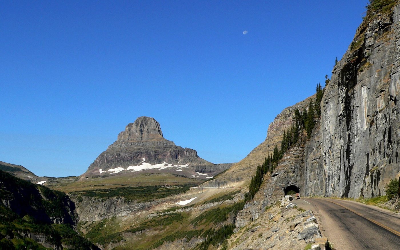 Going-to-the-Sun Road cut into a cliff with Clements Mountain ahead in Glacier National Park