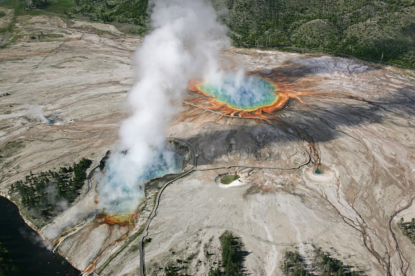 Aerial view of the Midway Geyser Basin with Excelsior's steam plume beside the colorful spring
