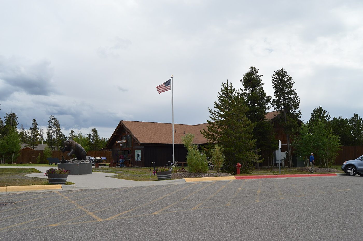 Entrance building and flagpole at the Grizzly and Wolf Discovery Center