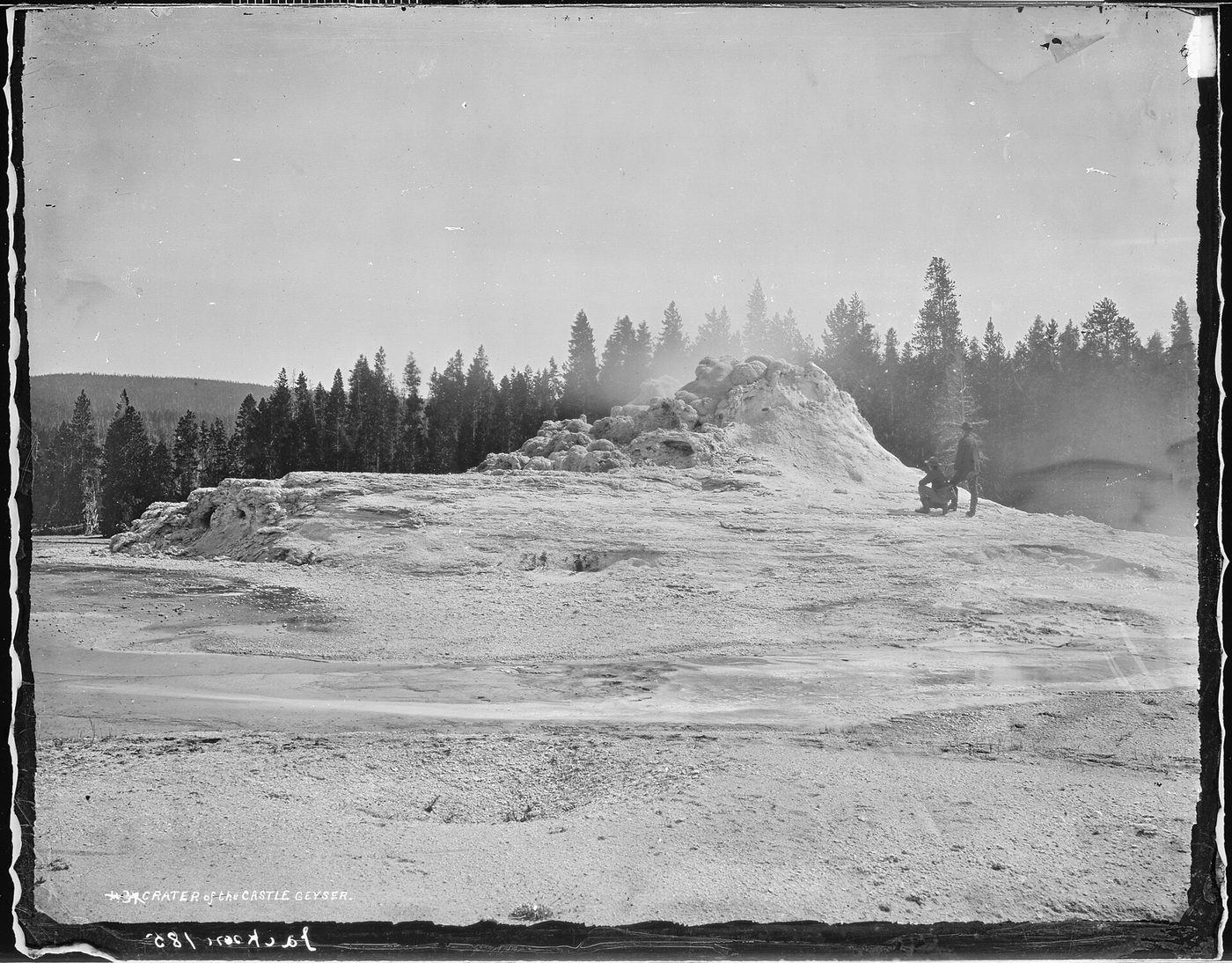 An 1870s glass-plate photograph of the Castle Geyser cone in Yellowstone