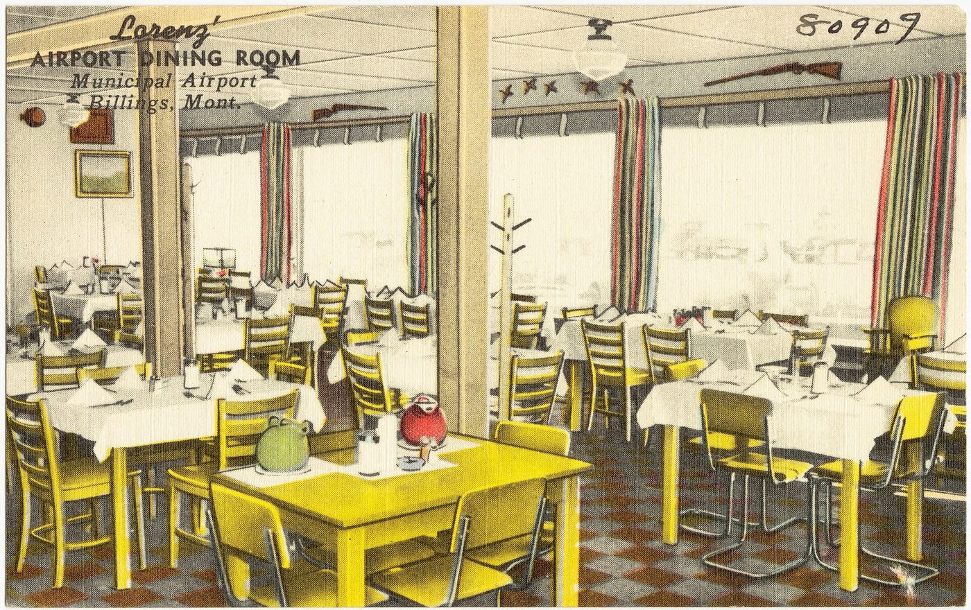 A mid-century Montana dining room with yellow chairs and white tablecloths