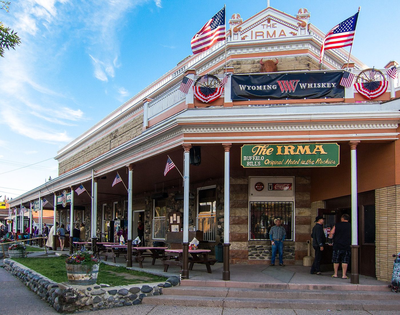 The flag-draped frontage of Buffalo Bill's Irma Hotel on Sheridan Avenue