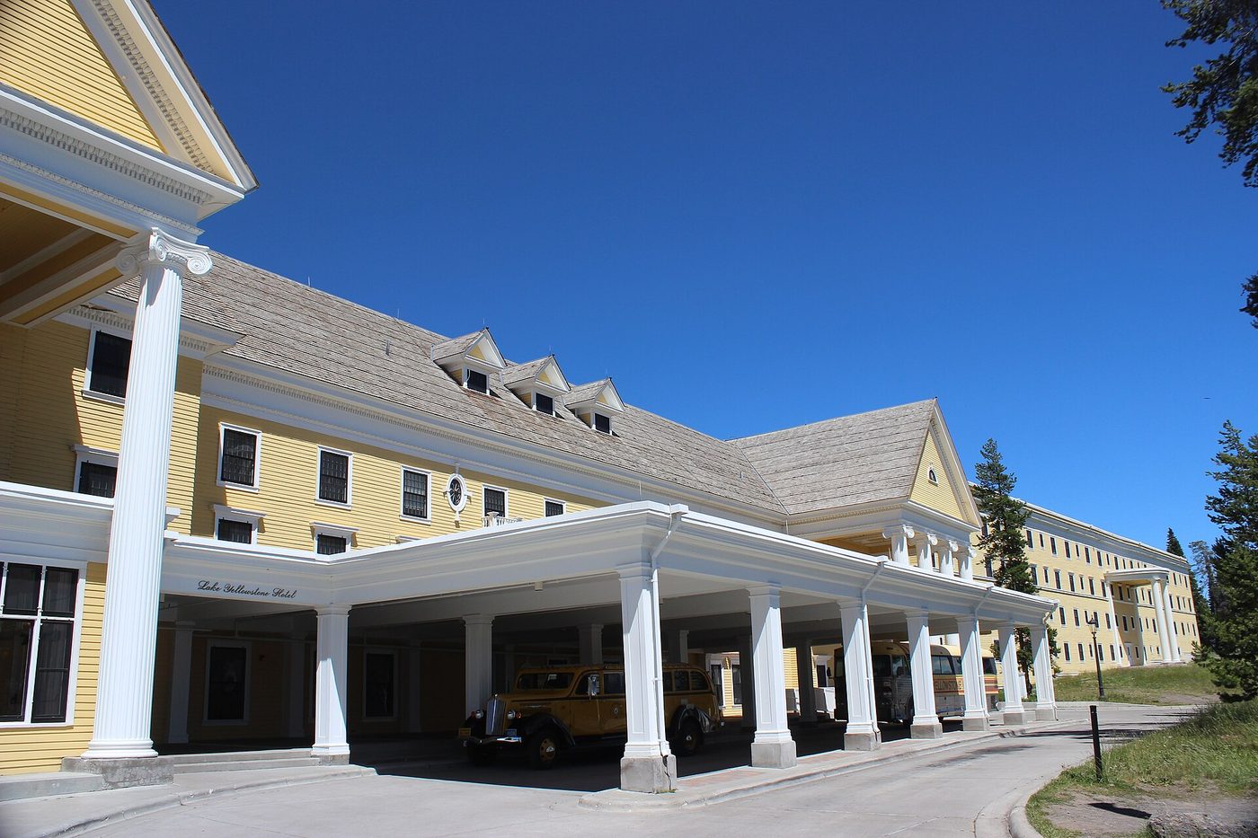 The long yellow frontage and porte-cochere of the hotel on the north shore of Yellowstone Lake