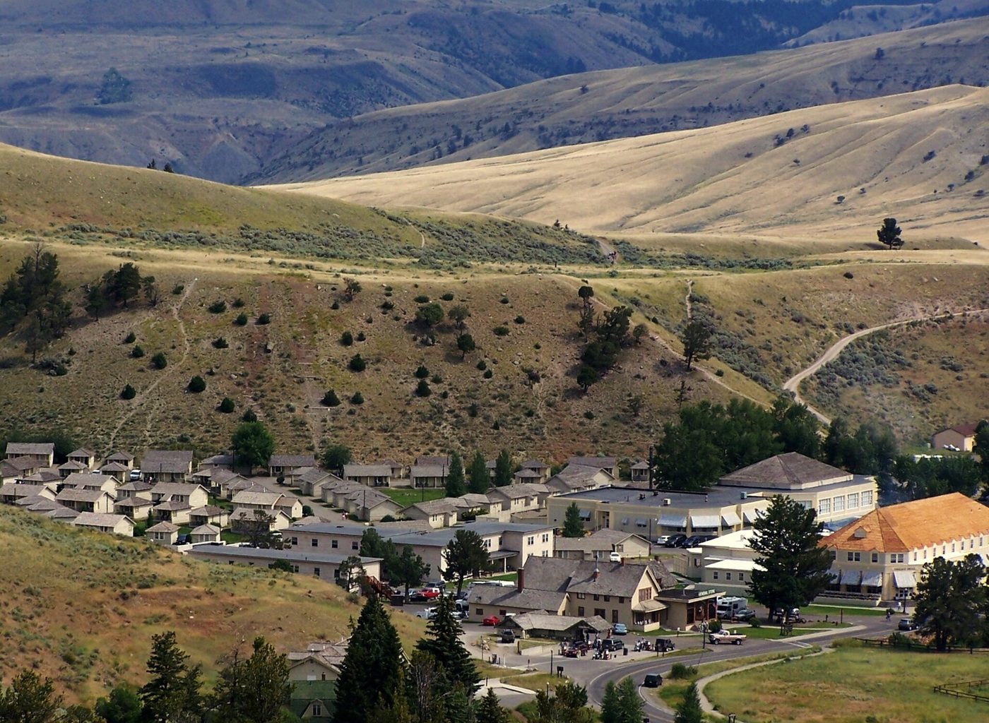 Mammoth village and the Fort Yellowstone buildings seen from the hillside above, with dry hills beyond