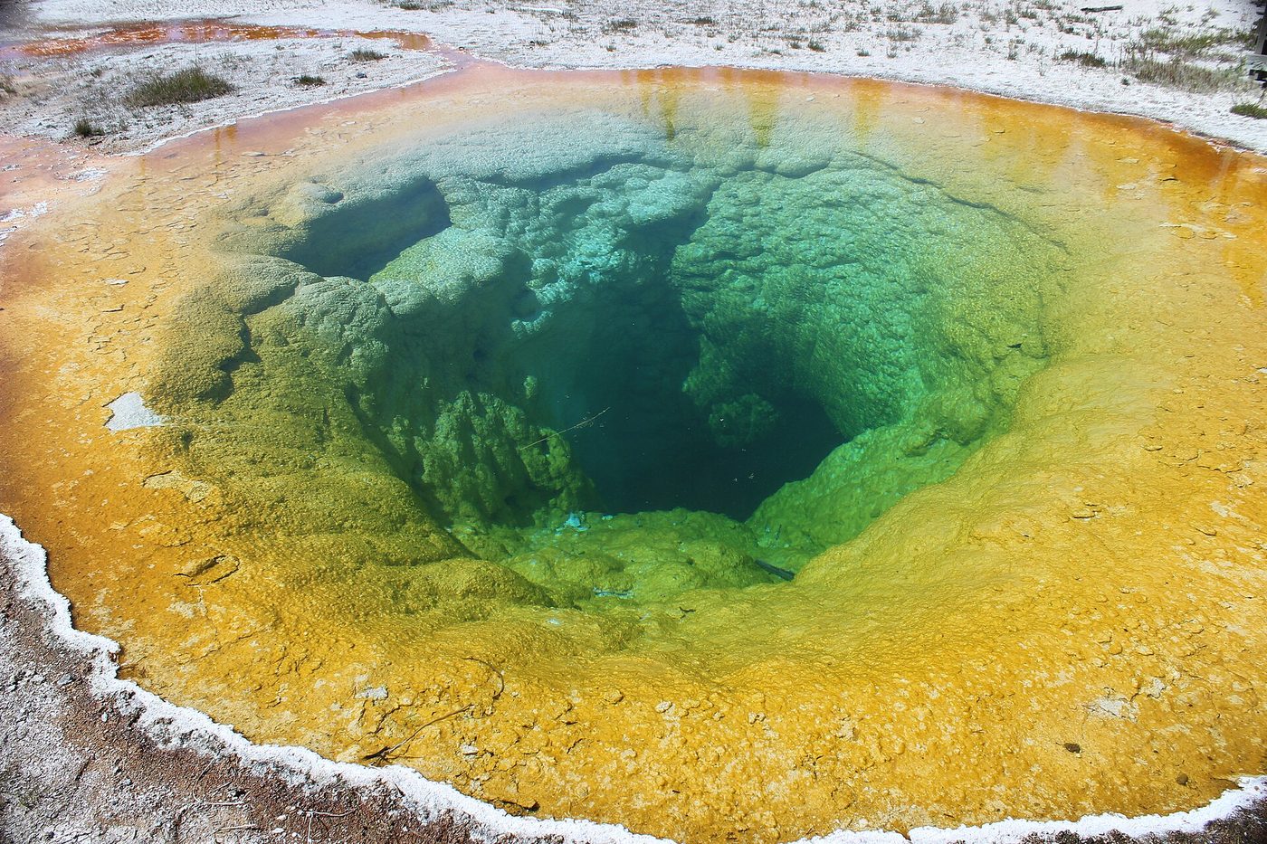 Morning Glory Pool with a deep green center ringed by yellow and orange bacterial mats