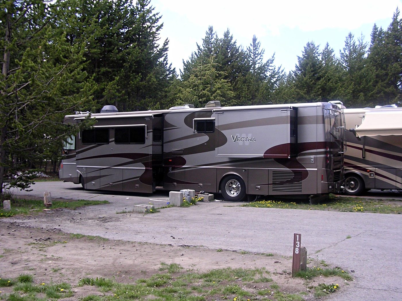 A large motorhome parked on a hardstanding site at an RV park in the park
