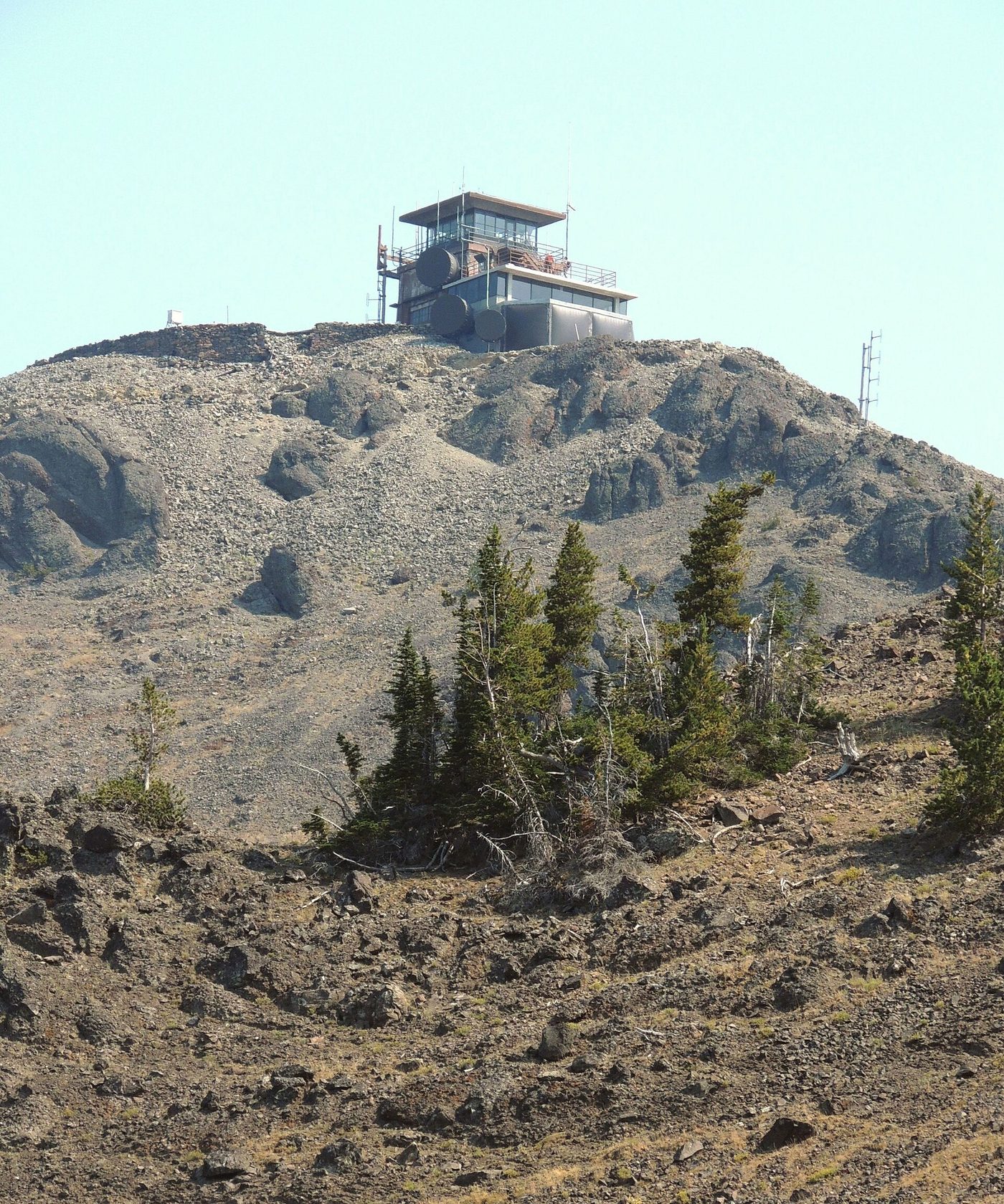 Fire lookout building perched on the rocky summit of Mount Washburn
