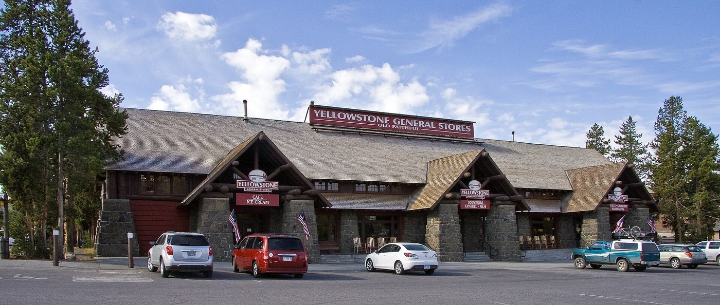 Cars parked outside the long timber Yellowstone General Store at Old Faithful