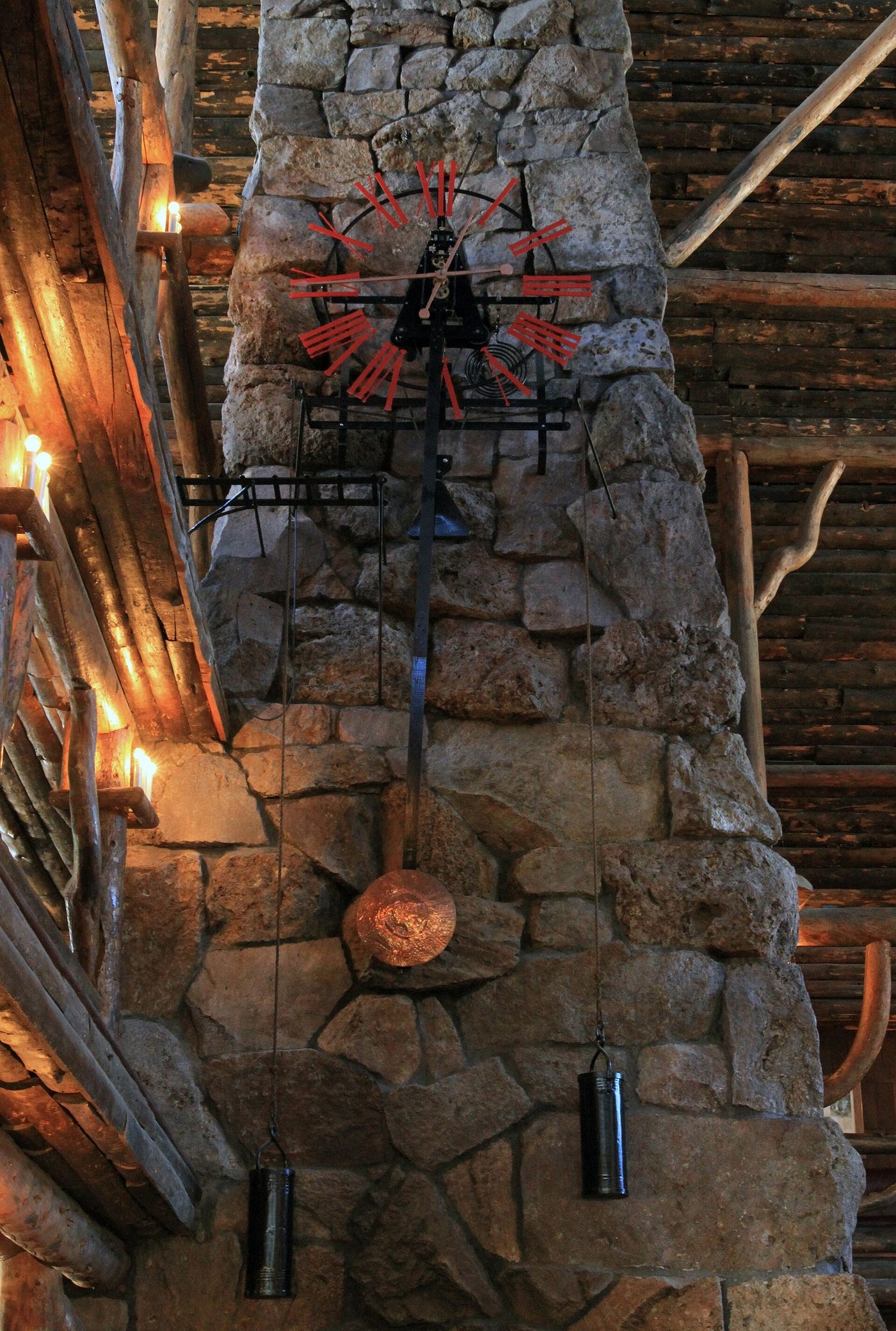 The hand-crafted copper, wood and wrought-iron clock mounted on the stone chimney in the lobby