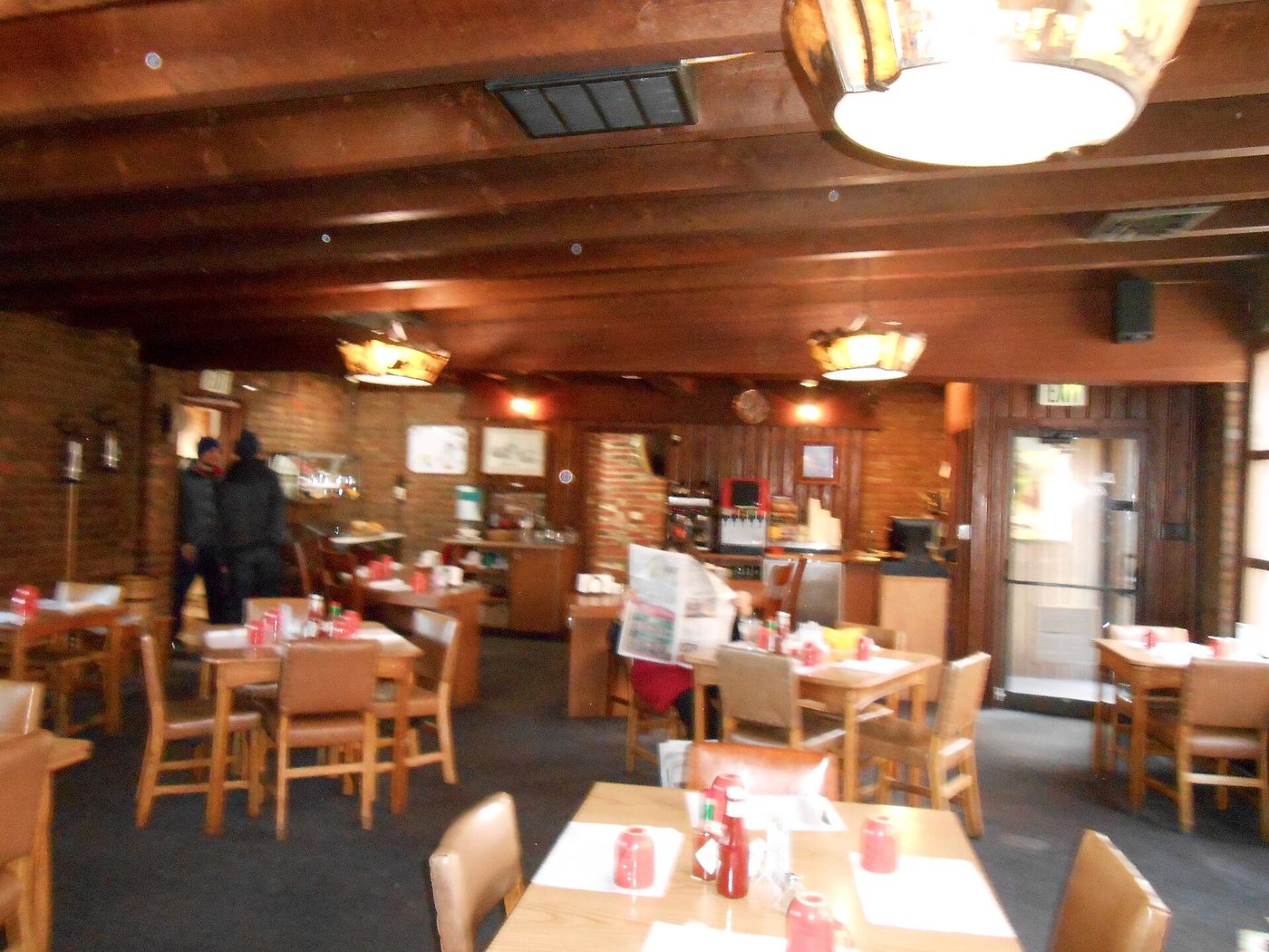 A wood-panelled Montana lodge restaurant with tables set for dinner