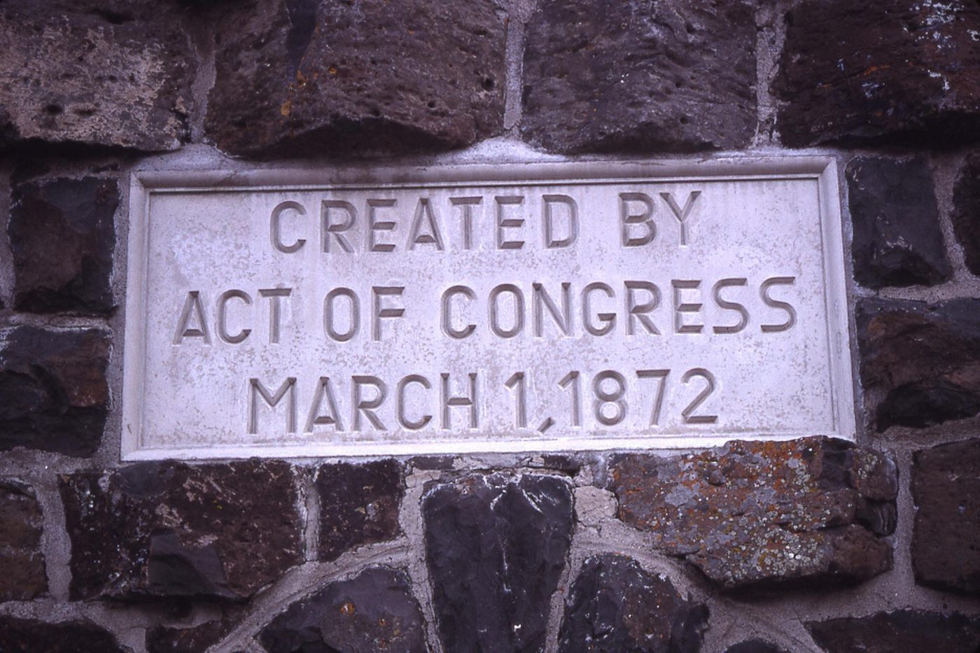 Stone plaque reading Created by Act of Congress March 1 1872 set into the Roosevelt Arch