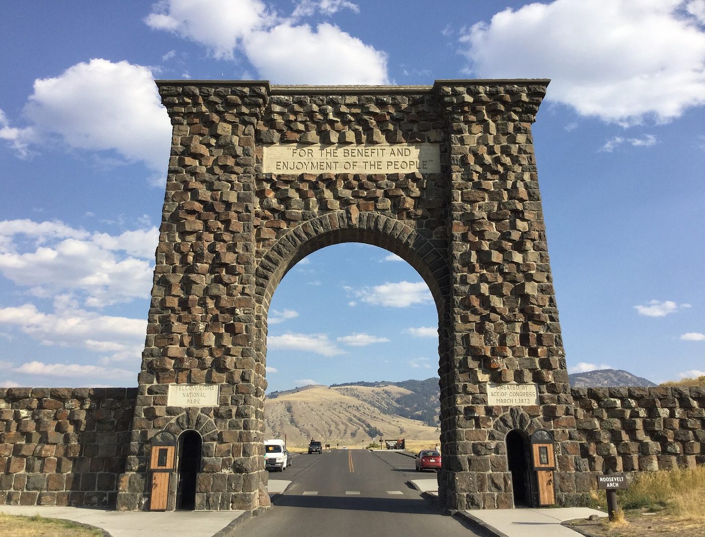 Stone Roosevelt Arch framing the road into the park at the North Entrance