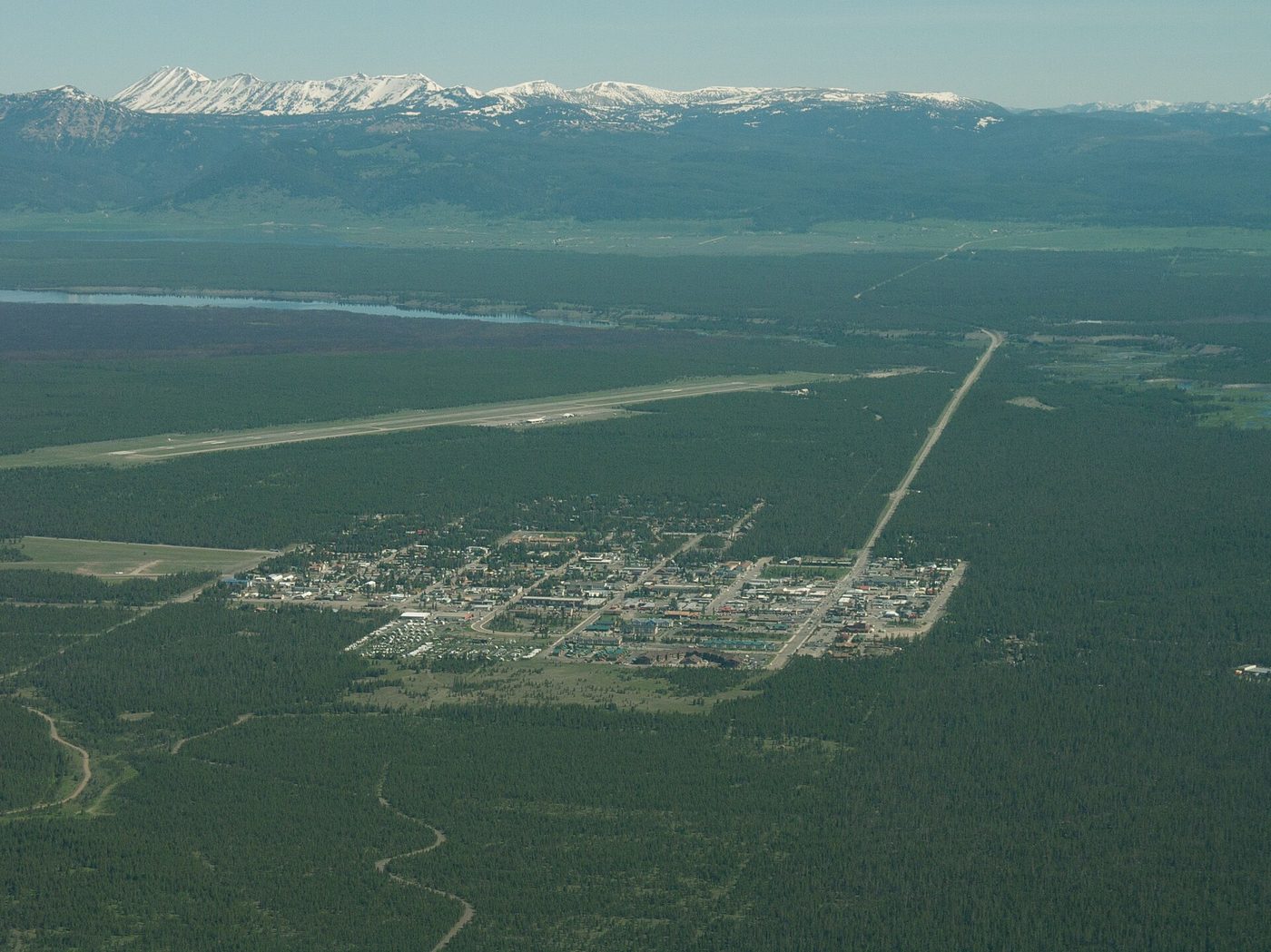 Aerial view of the grid of West Yellowstone with its airport runway and surrounding forest