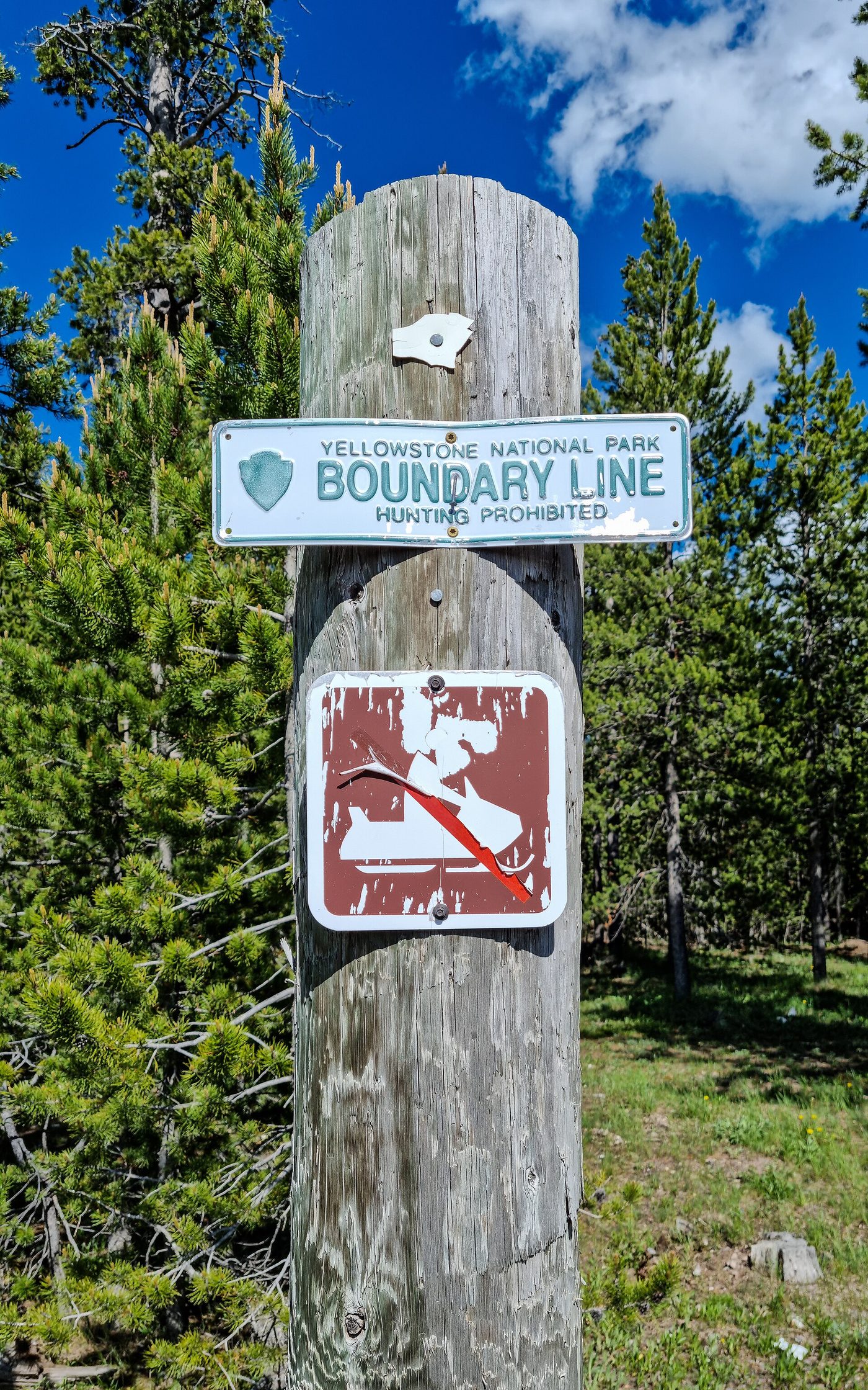 Yellowstone National Park boundary line sign on a post at Boundary Street in West Yellowstone