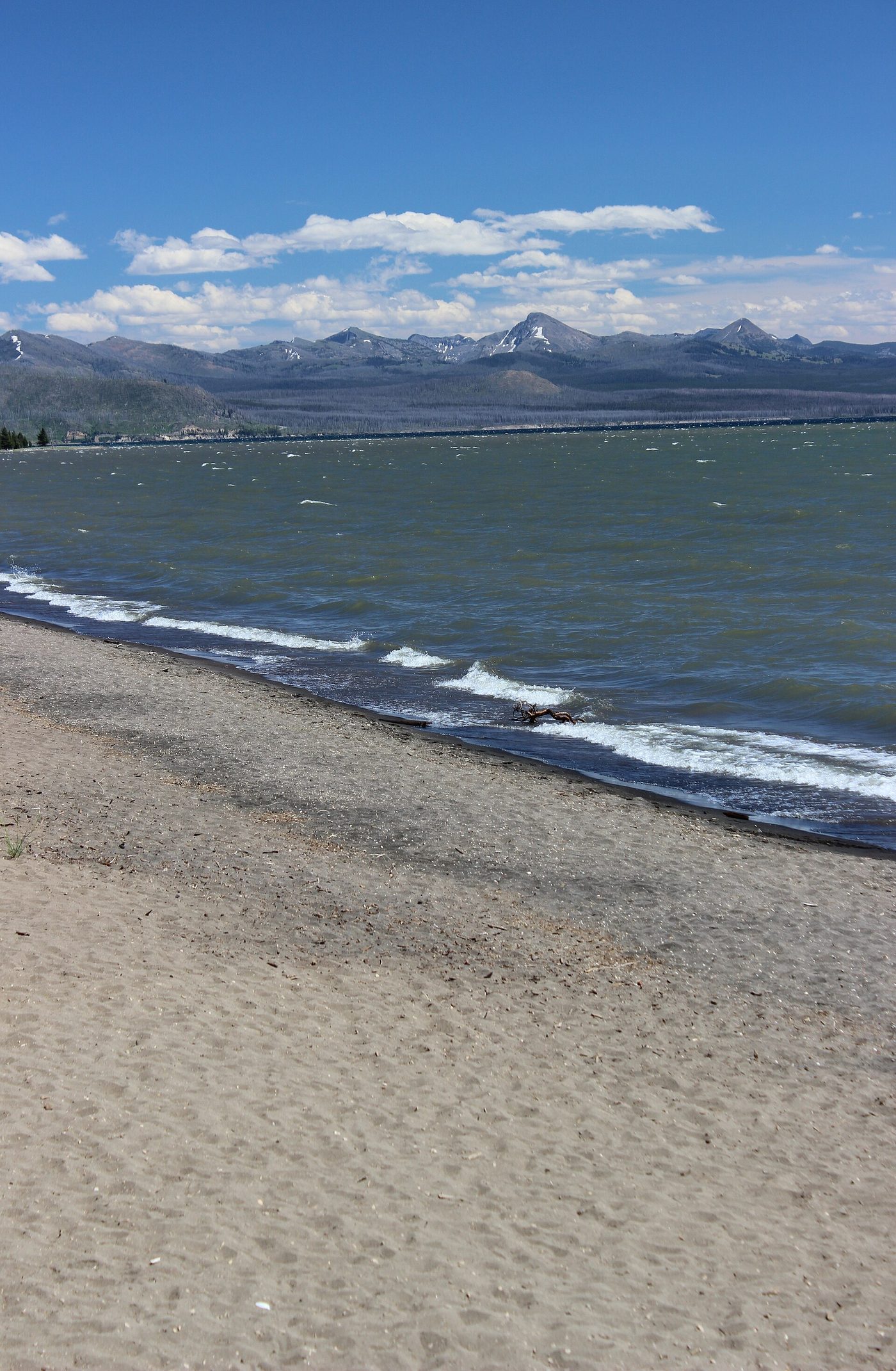 A sand and gravel beach on Yellowstone Lake with the Absaroka range across the water