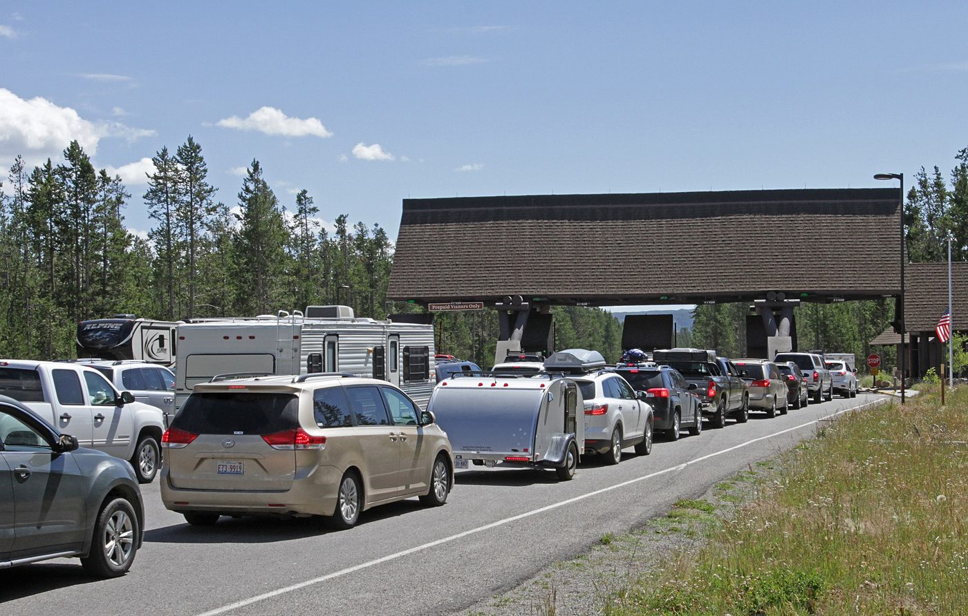 Cars and RVs queued at the West Entrance station of Yellowstone National Park in July